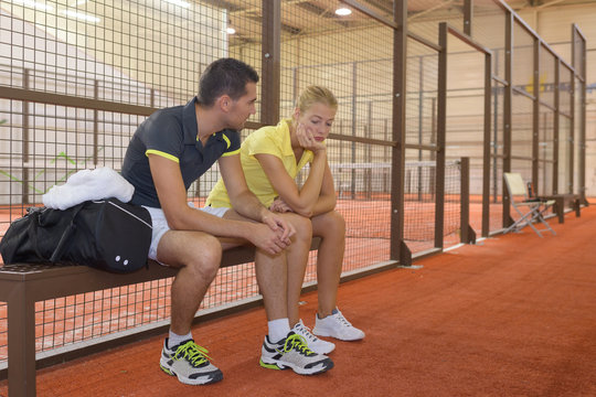 male tennis player calms distressed female partner