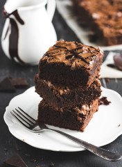 Chocolate brownie cake piece stack on plate homemade pastries