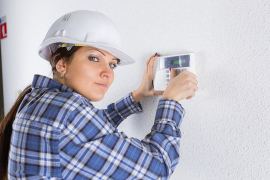 technician installing security system door sensor