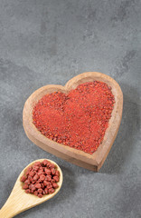 Fototapeta na wymiar Organic annatto powder and seeds - Bixa Orellana
