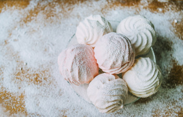 marshmallows on the glass plate on the wooden table
