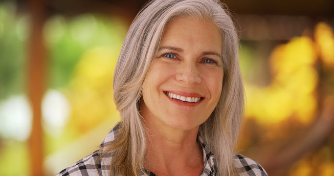 Lovely mature caucasian woman smiling outside