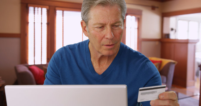 Caucasian mid aged man making an online purchase