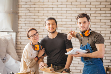 Portrait of three young craftsmen ready to work