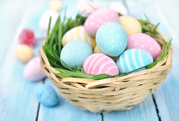 Fototapeta na wymiar Pastel painted decorated eggs on flower background, Easter holiday decor card, selective focus, shallow DOF, toned