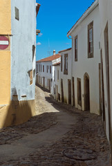 Fototapeta na wymiar Narrow street in Morvao Portuguese province village on a sunny day