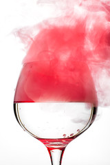 Wine glass with red smoke inside © bodiaphoto