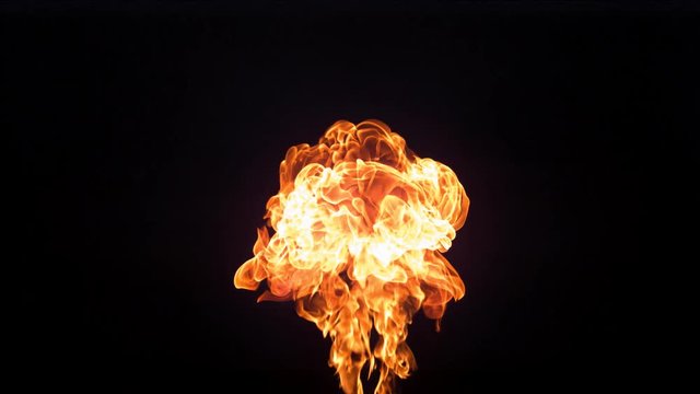 Flames rising up on a black background, slow motion