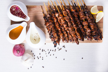 pork barbecue with peanut sauce, vinegar sauce and yoghurt sauce