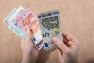 Hand holding American dollar  isolated on wooden background