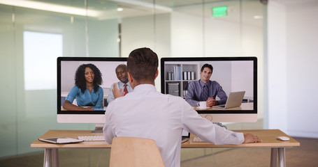 Diverse group of business associates having internet based web conference over video chat. Black Hispanic and Caucasian team of professionals communicating using modern technology