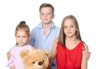 Brother and two sisters with a teddy bear
