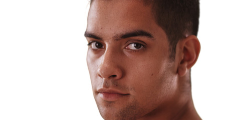 Obraz premium Close-up portrait of Millennial Hispanic man on white background with copy space. Latino guy looking at camera with copyspace.