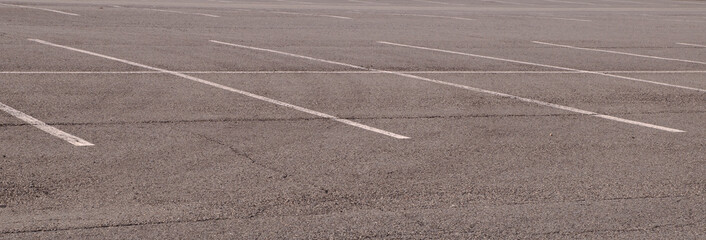An abstract shot of the faded lines for parking in a vacant parking lot © woodsnorth
