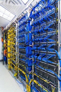 Rack with generic ethernet cat5e cables, part of a large company data center.