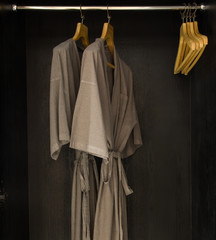  bathrobes hanging in wardrobe