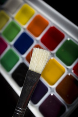 Colorful watercolors and a brush