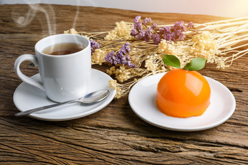 Orange cake on grunge wooden table