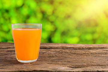 Glass of Fresh Orange Juice on wooden table