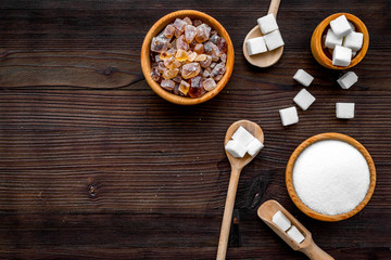 Sugar types. Cane, refind, granulated, cubes, candy sugar. Dark wooden background top view copy space