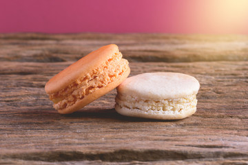 Different types color of macaroons on Old grunge wooden background
