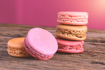 Different types color of macaroons on Old grunge wooden background