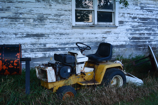 Broken Lawnmower and Old Garage