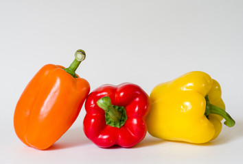 Three bell peppers together on white background