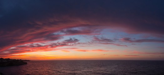 Fototapeta na wymiar Drone aerial view of a Fiery sunrise with multicolored clouds. Mallorca Island, Spain. Summer season