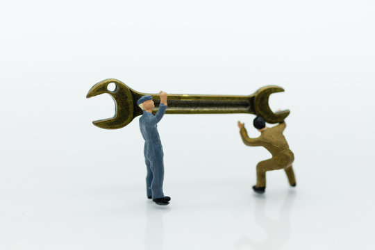 Miniature people: Workers are carrying a wrench. Image use for business industry concept.