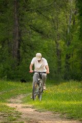 Fototapeta premium A young man with a Bicycle on nature background