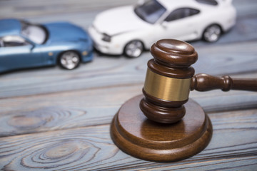 hammer of the judge. two collided cars, accident.
