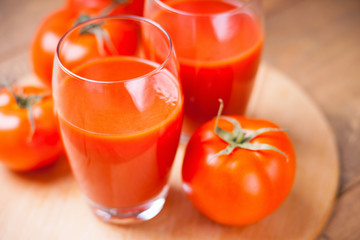 Glasses of fresh tomato juice and tomatoes 
