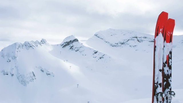 Mountain skiing are on the background of snowy mountains, 4K.
