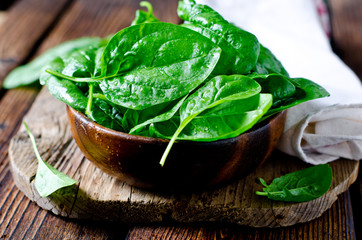 Fresh spinach on a cutting wooden board