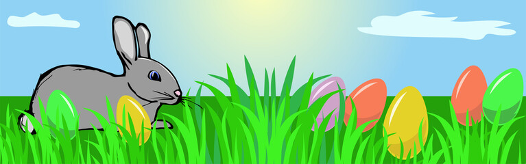 Easter bunny on a meadow.  Easter eggs