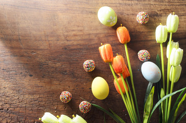 Fancy Easter eggs and tulips flower decoration on wooden backgrounds with copy space for your text