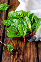 Fresh chard leaves in a wooden bowl