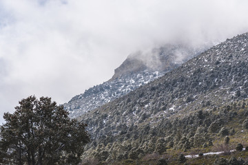 Cold front rolling over rocky mountain