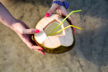 coconut with tubes on the beach.A cooling drink.Thailand