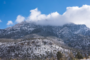 View of the snowy mountain with clouds around it