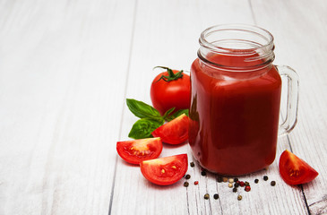 Fototapeta na wymiar Jars with tomato juice