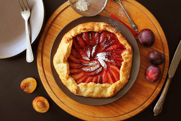 Healthy homemade wholegrain fruit galette with plums sugar powder
