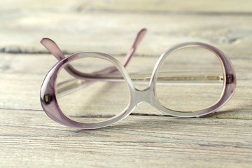 Fototapeta na wymiar eyeglasses on wooden table