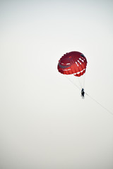 tourists flying on a parachute behind the boat.Entertainment on vacation