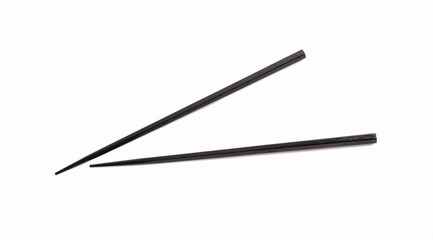 Black chopsticks on white background.