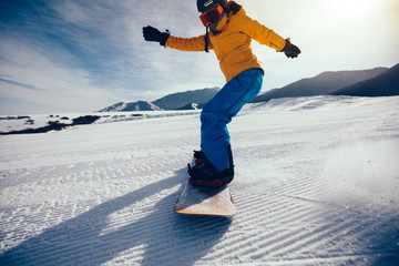 snowboarder snowboarding in winter mountains