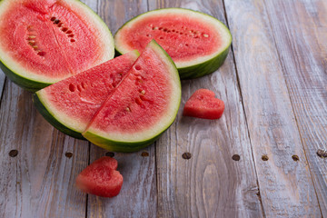 Fresh ripe watermelon slices and mint on wooden table