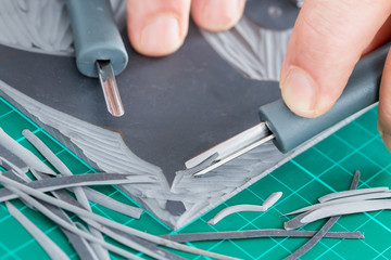 Lino cutting close up. Lino being cut by hand.