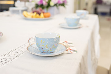 Festive tea drinking. The table is served with homemade cakes, cake, tea, fruits and flowers. Visiting grandmother.
